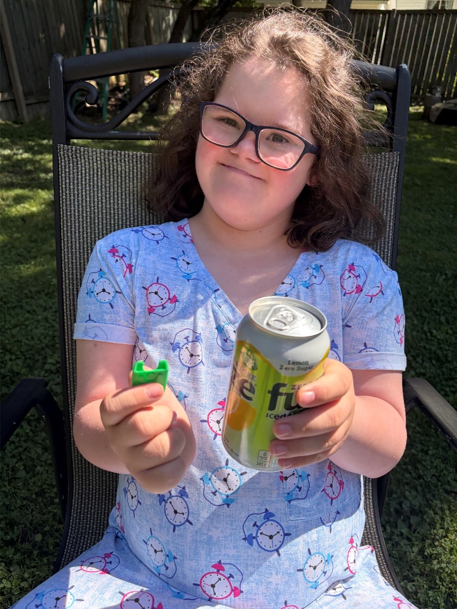 Mira using a Can Tab Opener to open a can of iced tea.