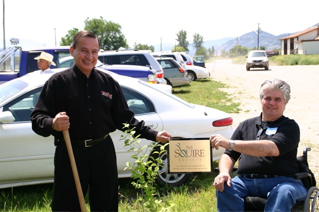 Chief Steward Phillips and Greg Pyc, Neil Squire National Operations Manager, planting a tree together at the first Footprints Open House in 2006.