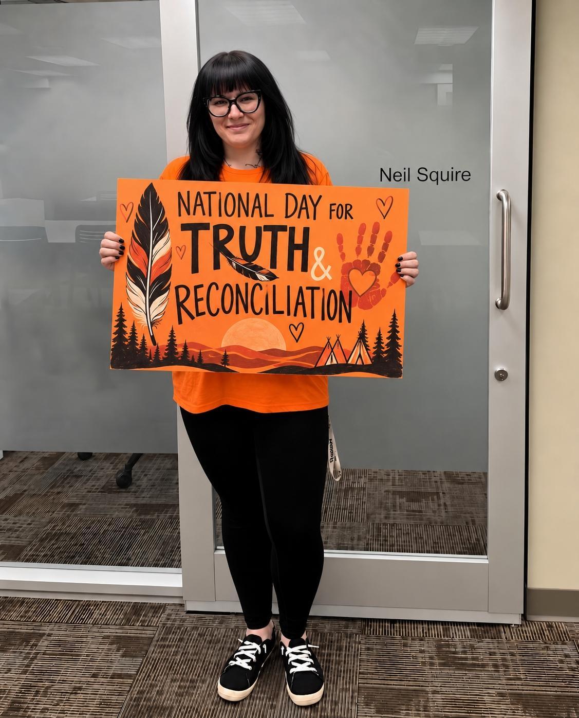 Shannel from our Calgary office holding a sign that says, "National Day for Truth and Reconciliation"