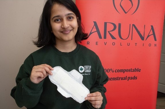 Rashmi holding one of the compostable menstrual pads that her startup designed.