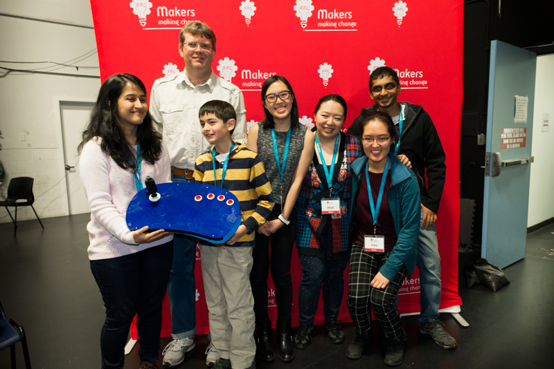 Rashmi and her team at the Access Makeathon, including Timothy, who is holding the adapted controller they designed.